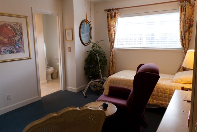 Private resident room with bedding and seating