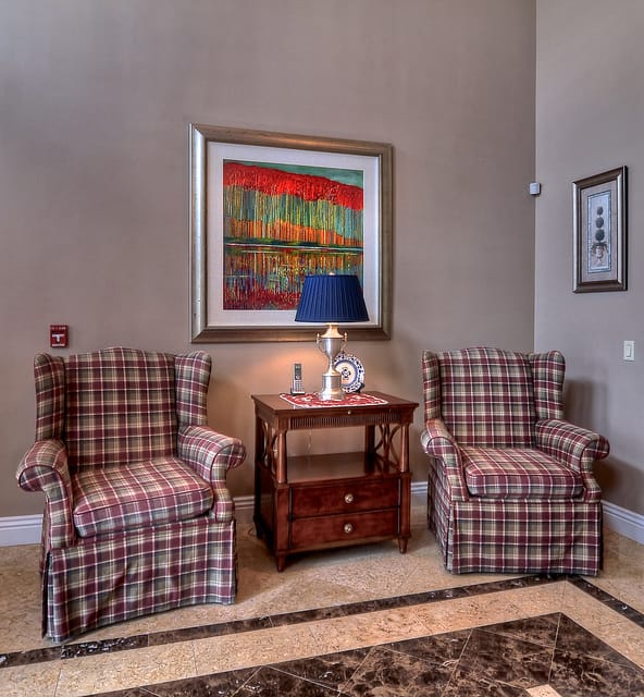 Common area with two comfortable chairs and artwork