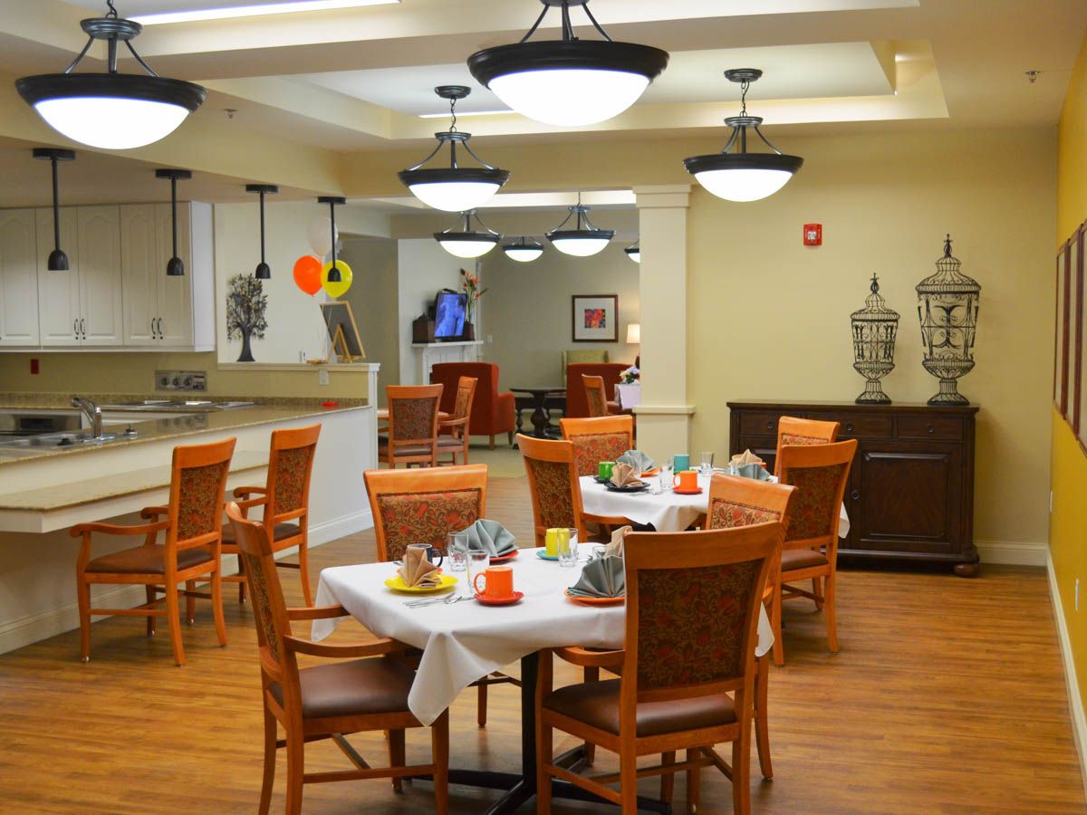 Brightly lit dining room with tables set for a meal
