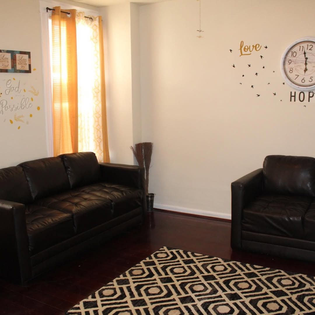 Comfortable common area with leather seating and decor