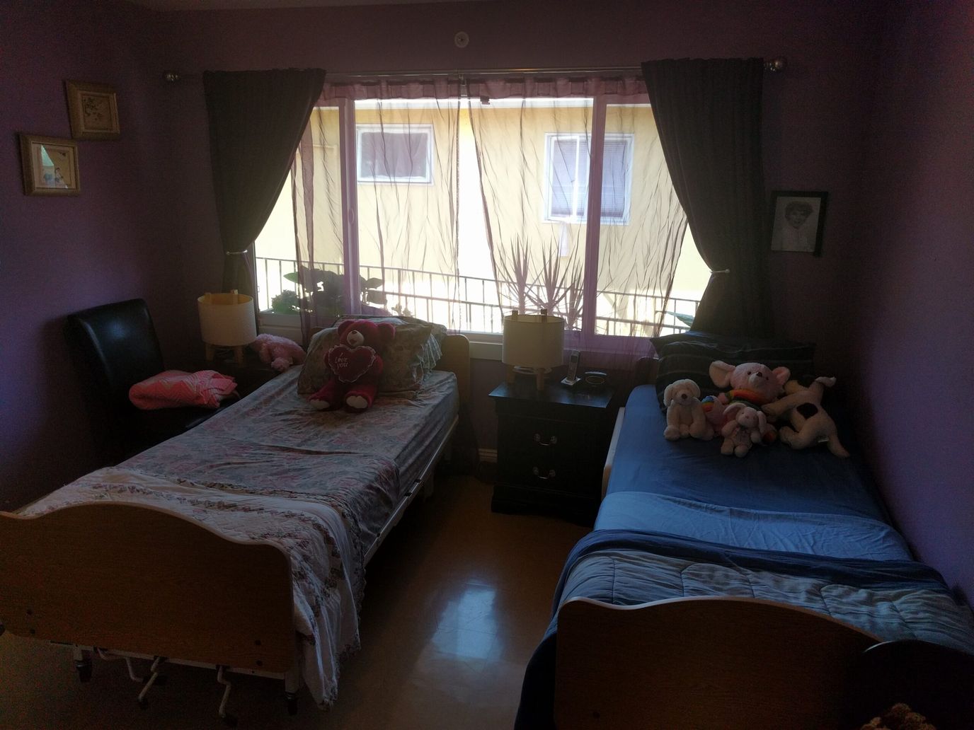 Cozy shared resident room with personal items and soft toys