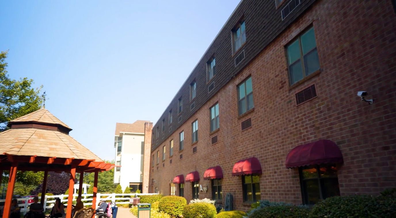 Exterior view of the facility with landscaping and a gazebo
