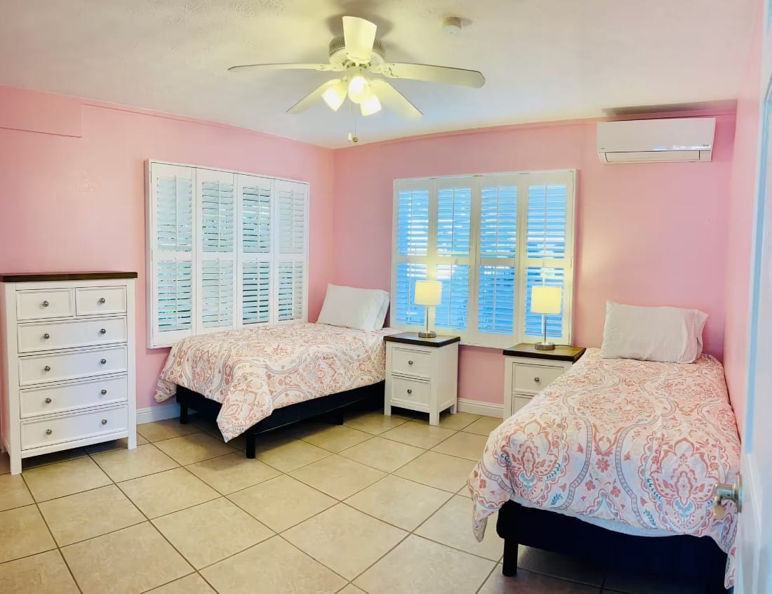 Bright shared room with two beds and light decor