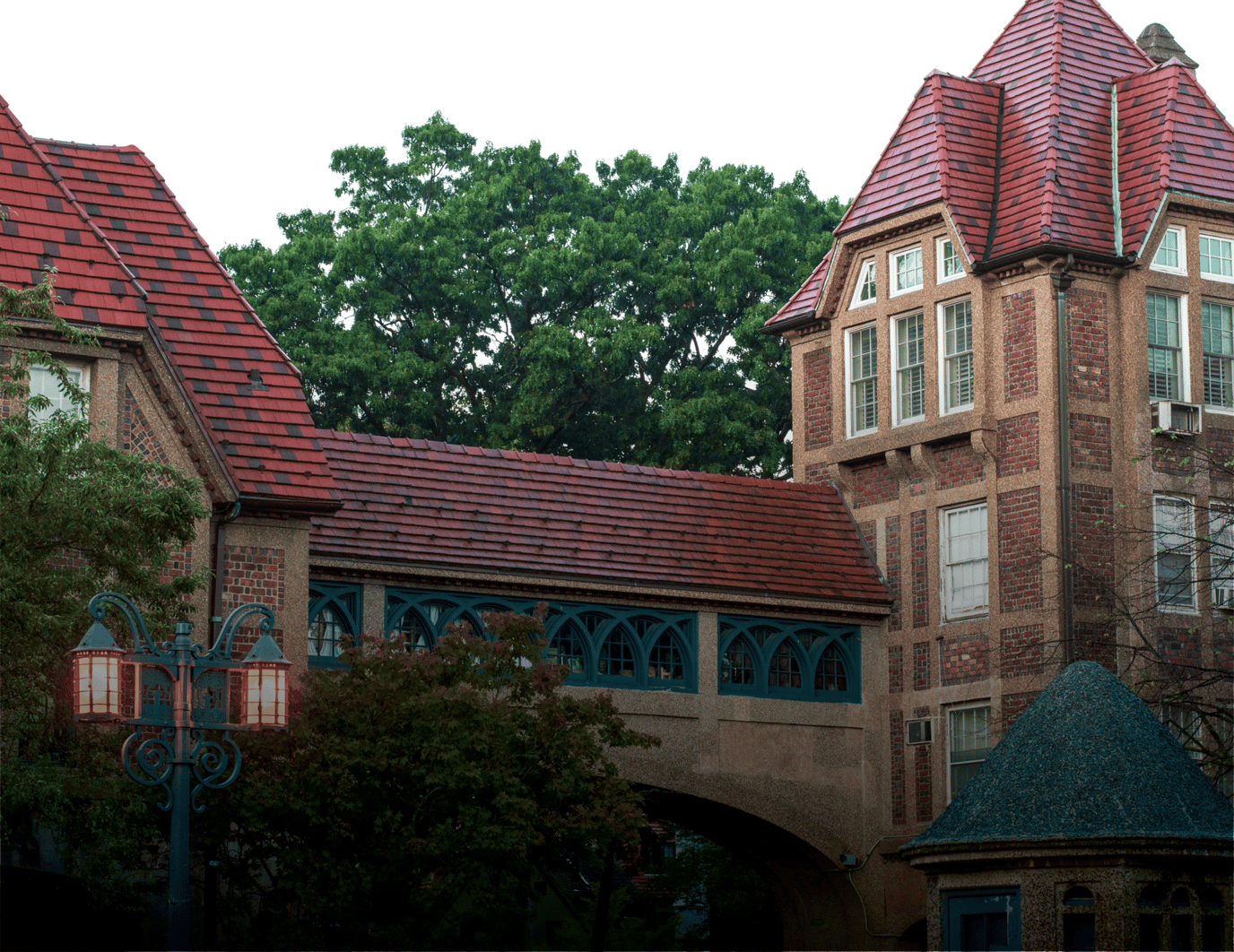 Exterior view of a building with a bridge and trees