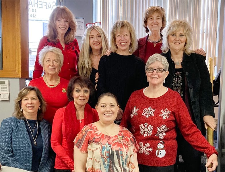 Group of staff members posing in festive attire