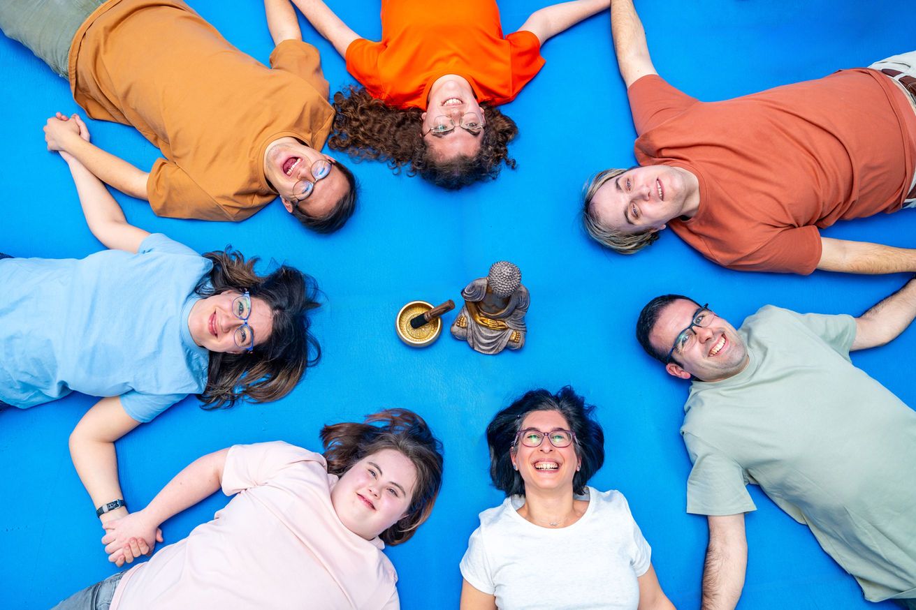 Group of smiling people enjoying a playful moment together.
