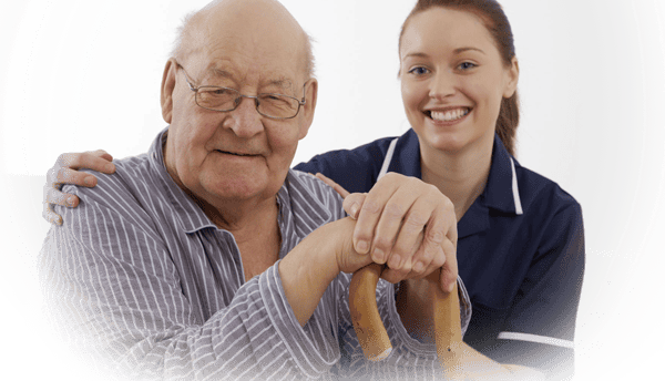 Senior resident with caregiver smiling together.