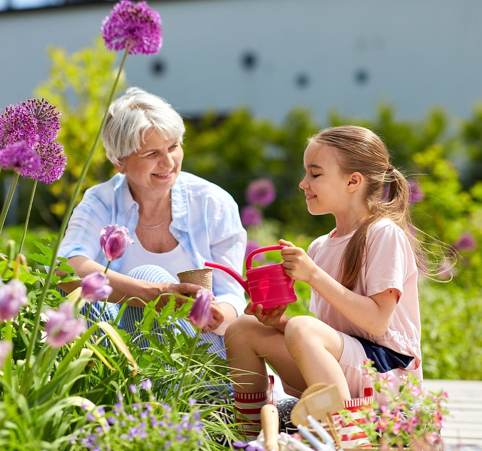 Senior woman gardening with a young girl