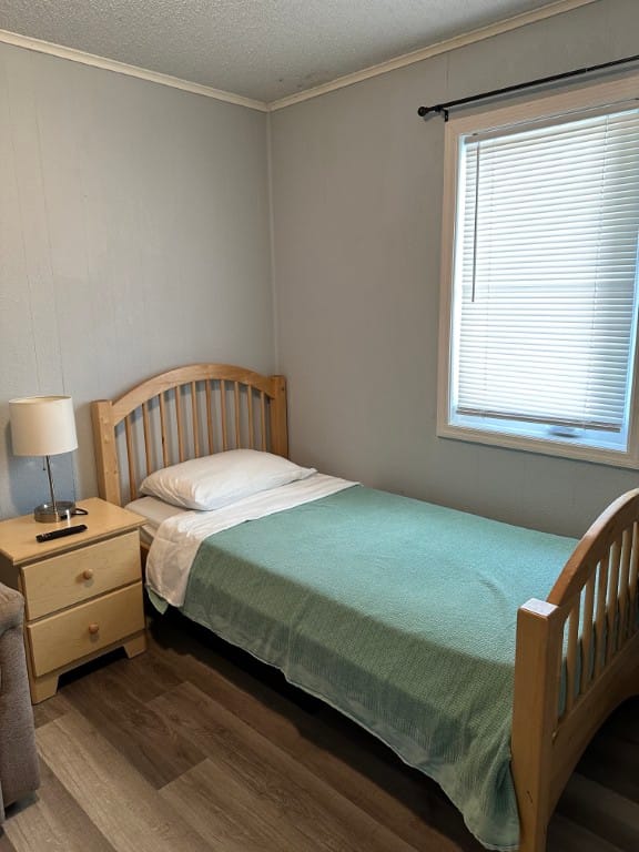 A small private resident room with a bed and lamp