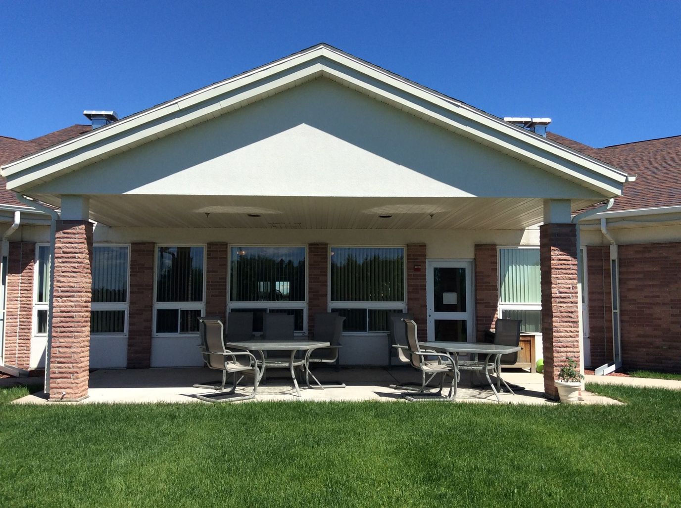 Outdoor seating area with tables in front of the facility