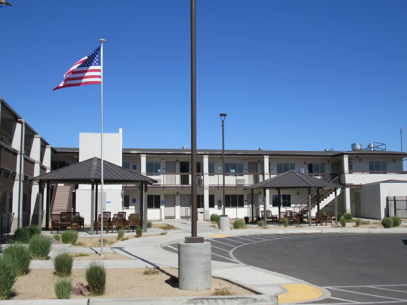 Exterior view of River's Edge Assisted Living with outdoor seating