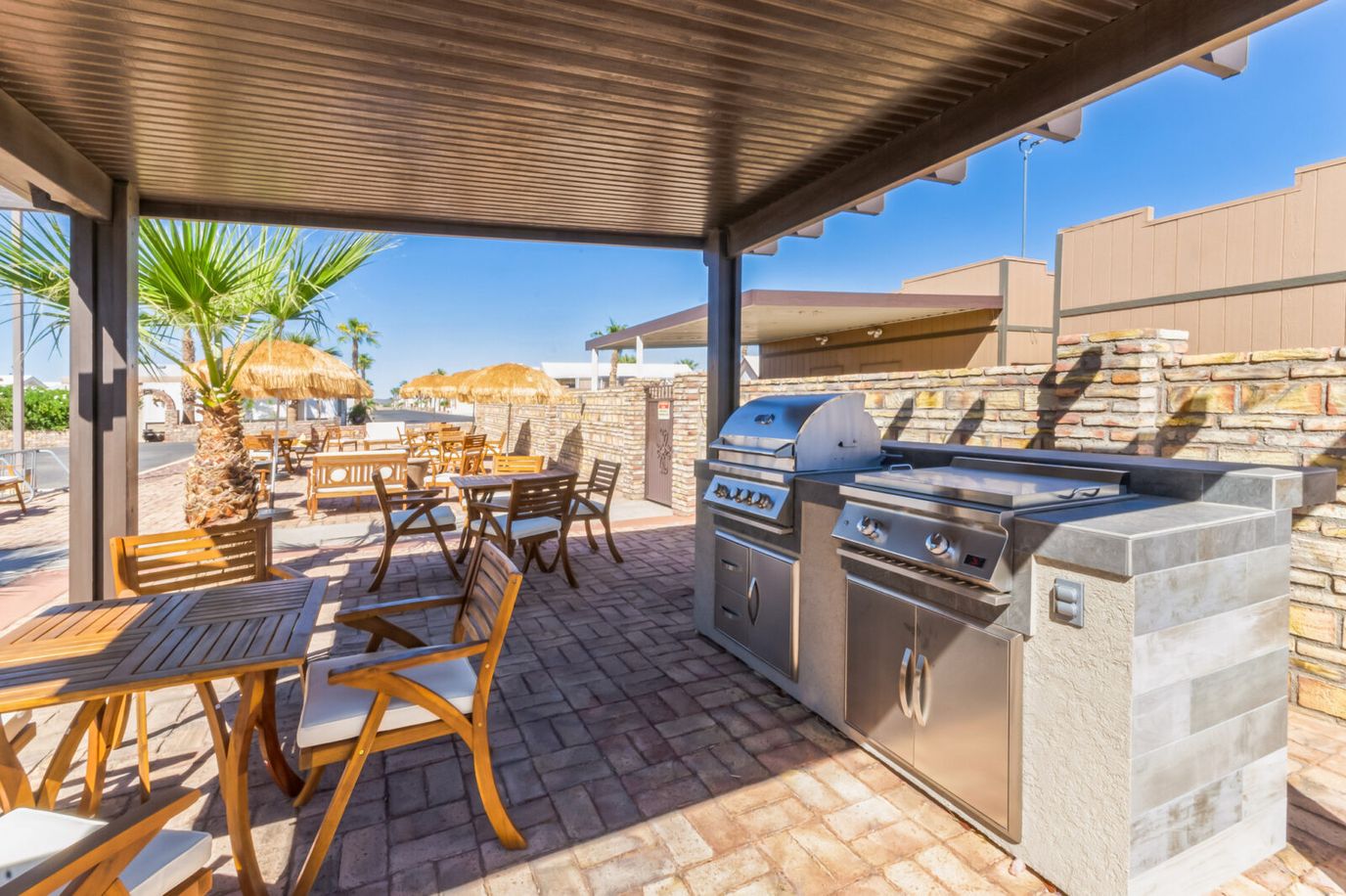 Outdoor grilling area with tables and seating
