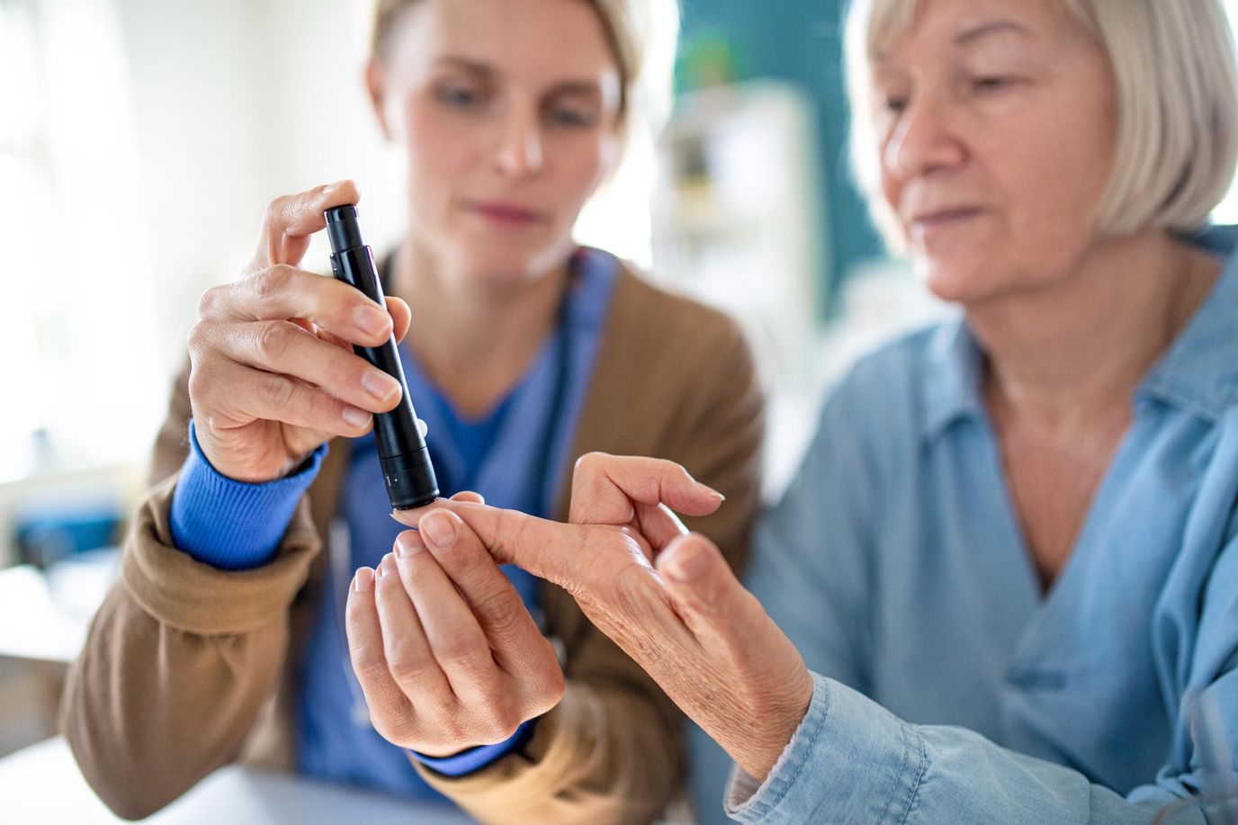 Caregiver assisting a resident with health check