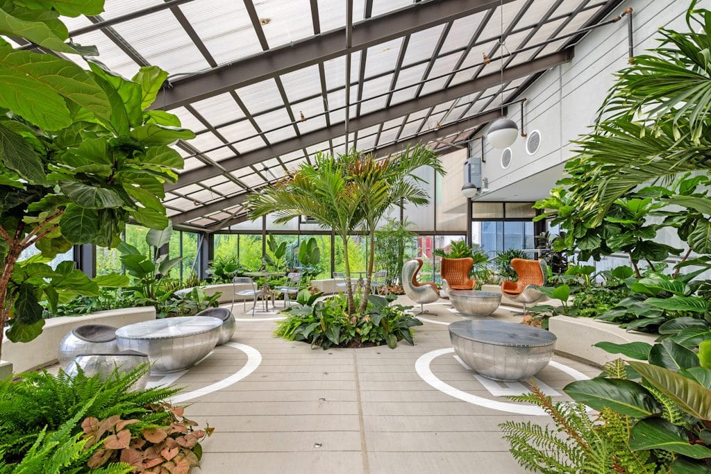 Indoor garden area with lush plants and seating