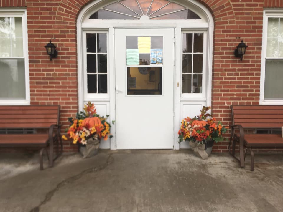 Entryway of Maple Hills Skilled Nursing facility decorated with flowers