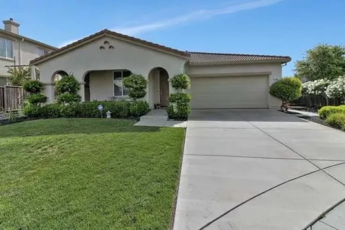 Front view of a residential building with green lawn