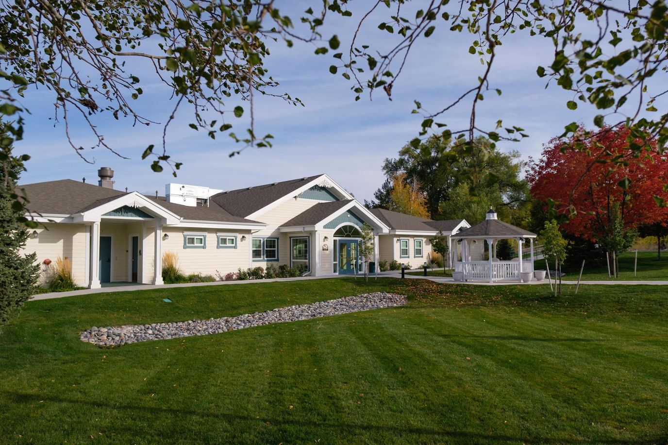 Exterior view of a senior living facility with outdoor space