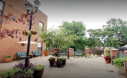 Outdoor garden area with benches and plants