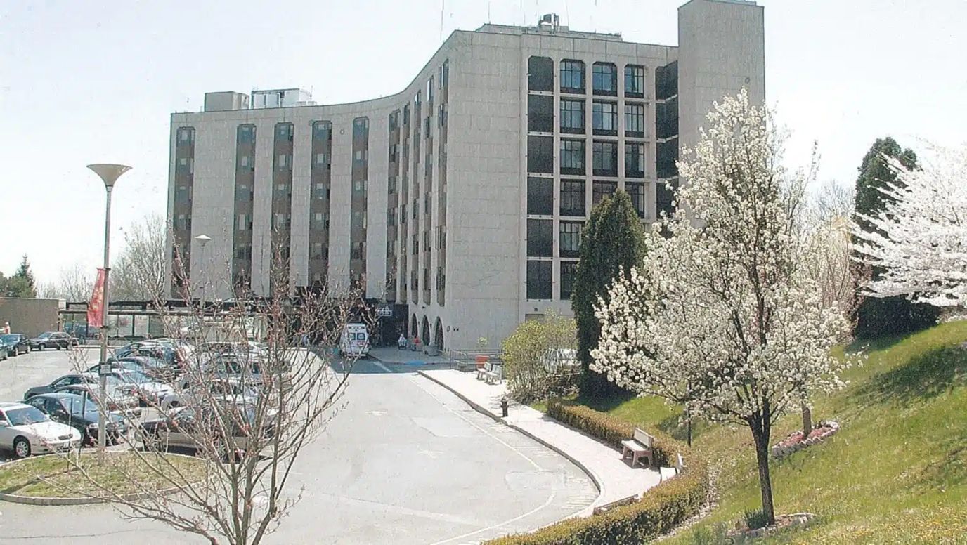 Exterior view of a senior living facility with blooming trees