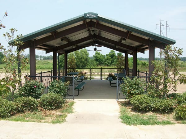 Outdoor pavilion with seating and vegetation