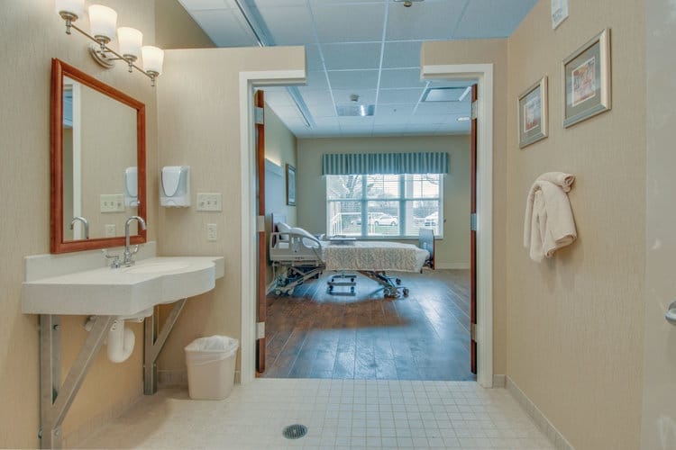 Private resident room with a hospital bed and window
