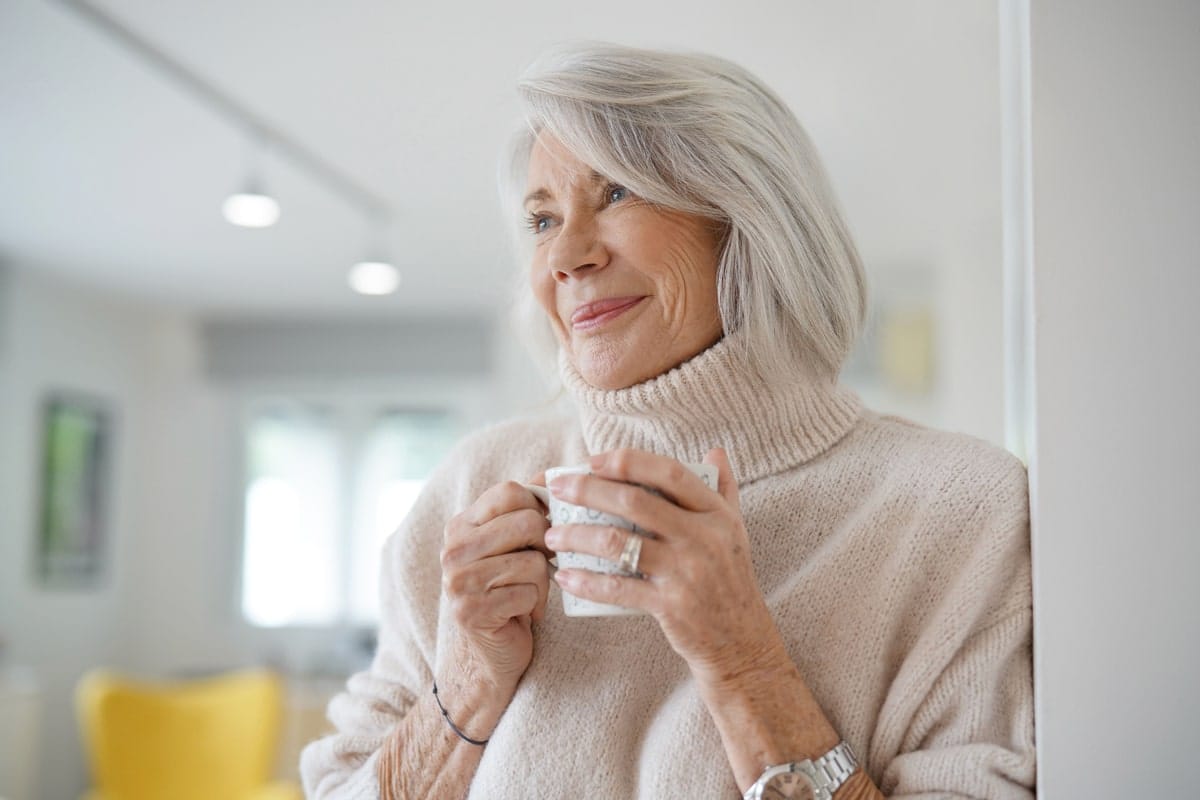 Senior woman enjoying a warm beverage indoors