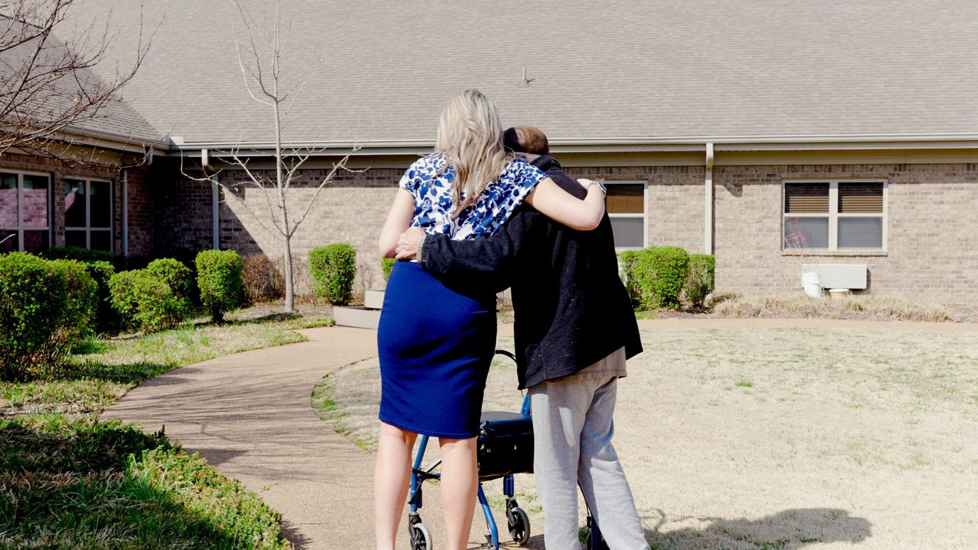 Caregiver assisting a resident outside the facility