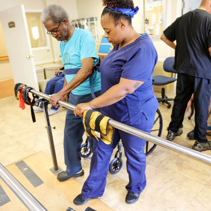 Staff assisting a resident with mobility training