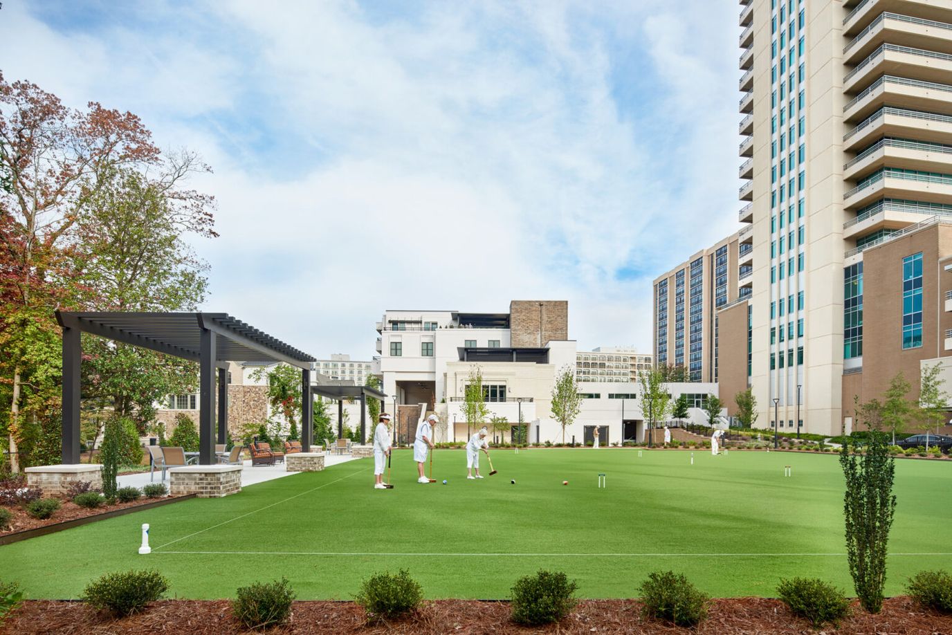 Residents enjoying a game of croquet in a spacious outdoor area