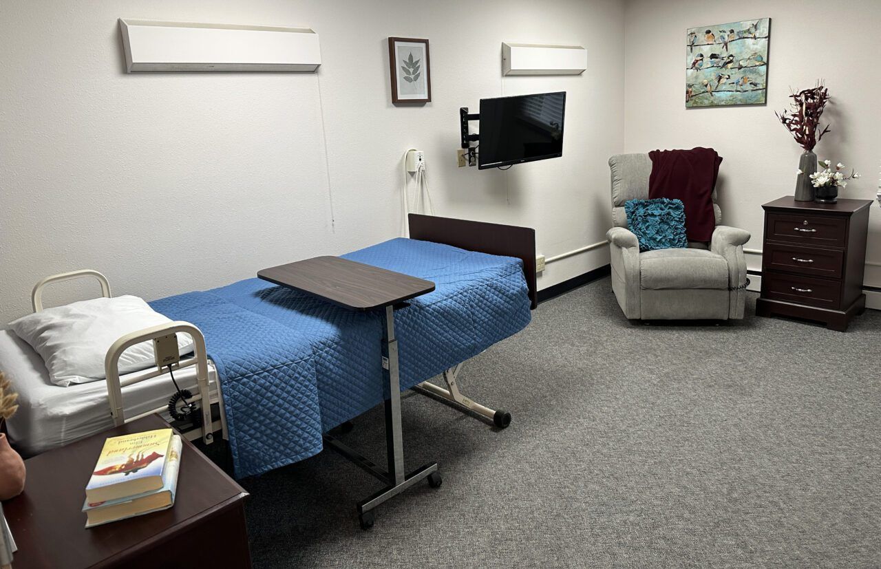 Comfortable private resident room with a bed and recliner