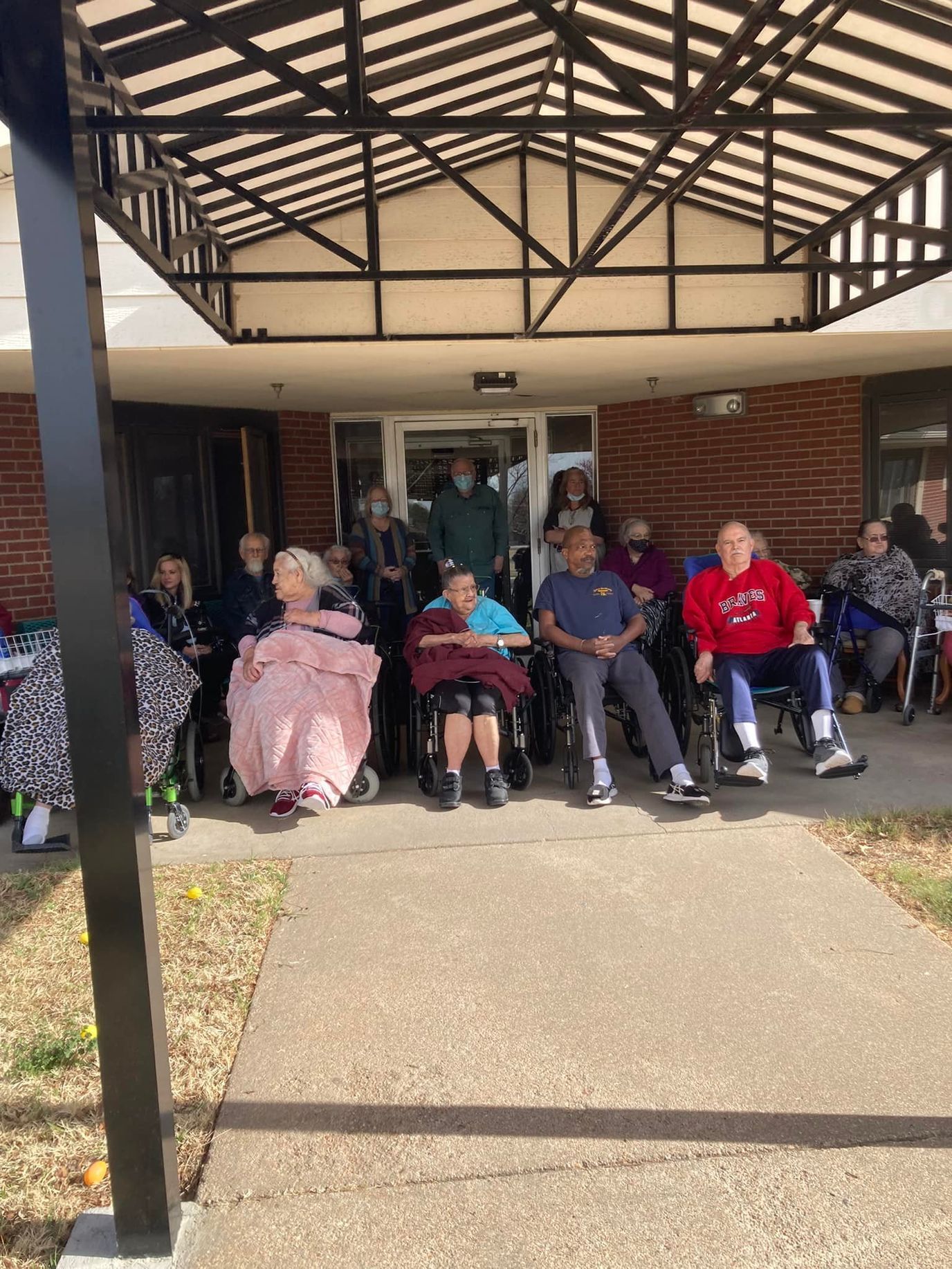 Residents enjoying outdoor seating on a sunny day