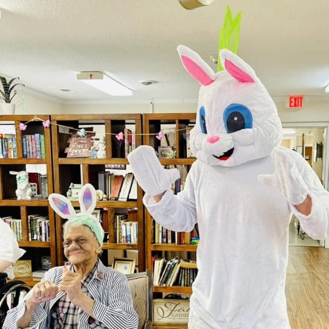 Residents enjoying an Easter celebration with a costumed bunny