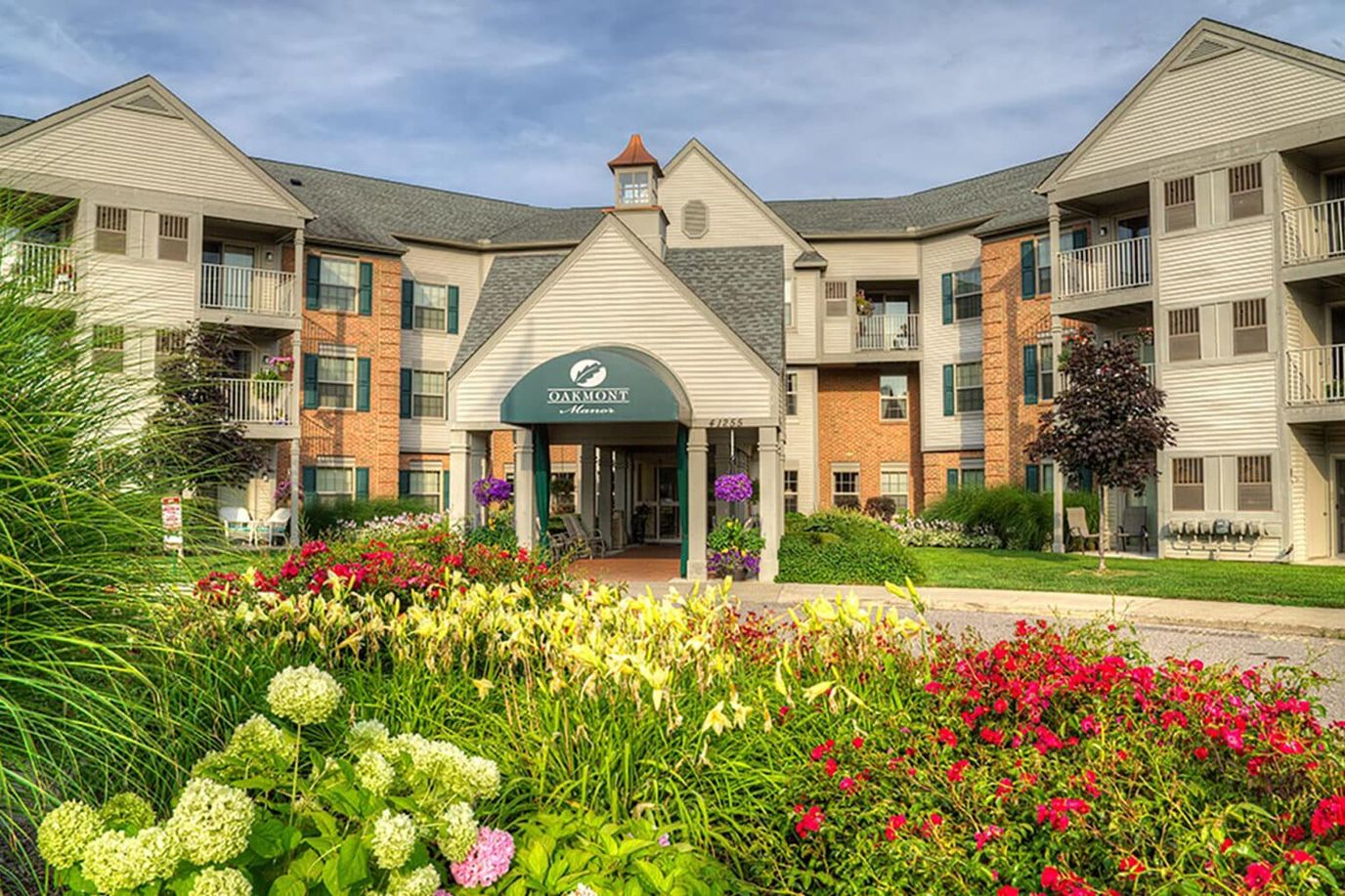 Exterior view of a senior living facility with gardens