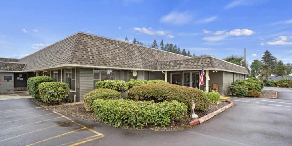 Exterior view of a senior living facility with landscaping