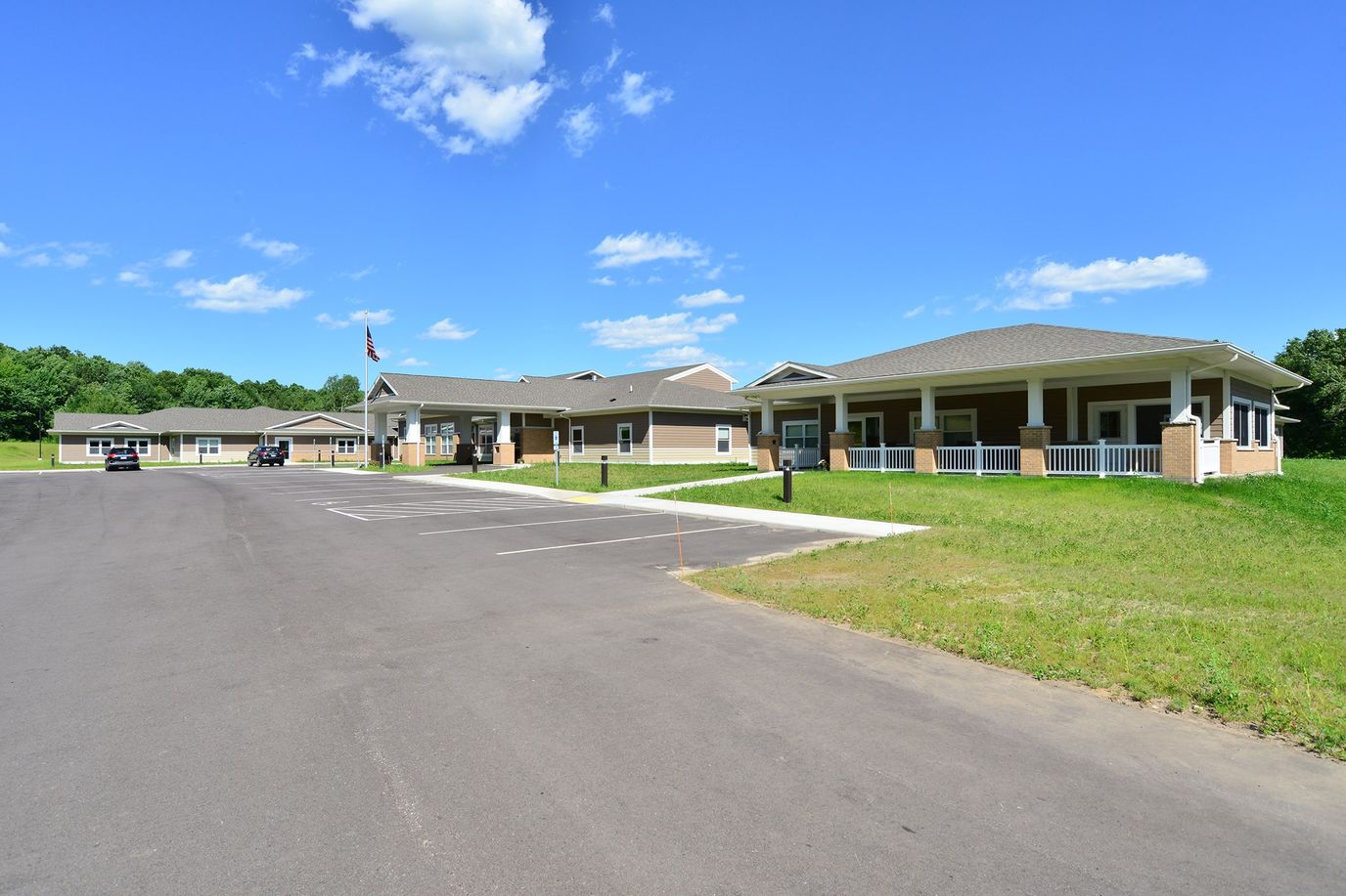 Exterior view of a senior living facility with parking
