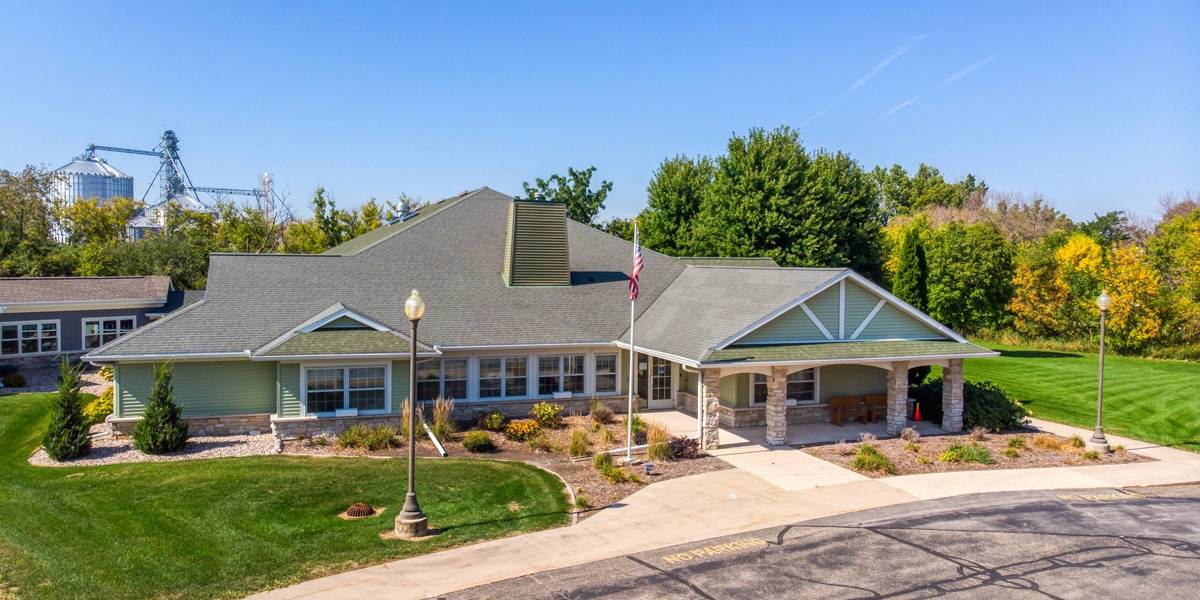 Exterior view of a green senior care facility building