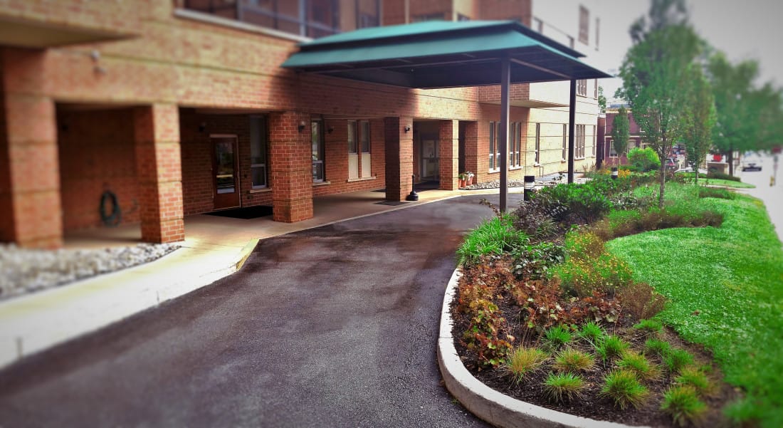 Exterior view of the facility entrance and garden area