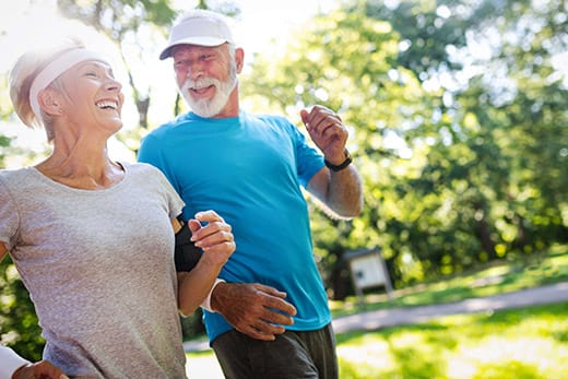 Active seniors jogging together in a vibrant park