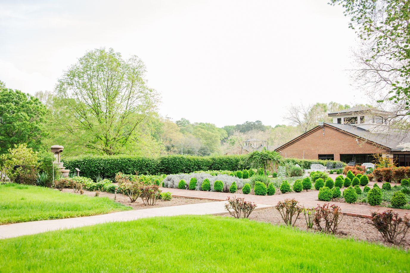 Well-maintained garden with walking path and building behind