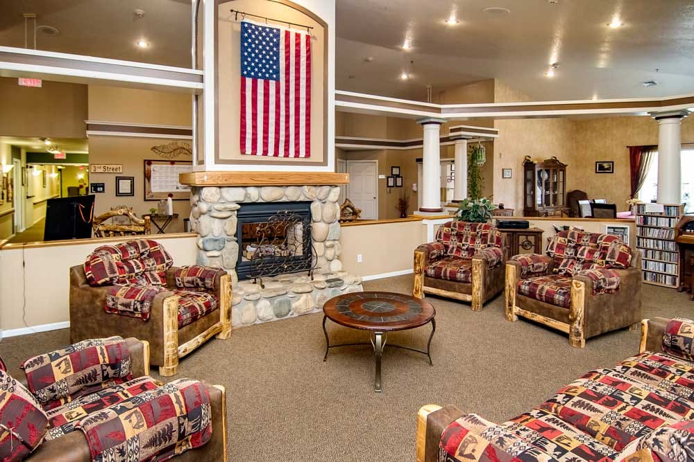 Common area lounge with rustic seating and fireplace