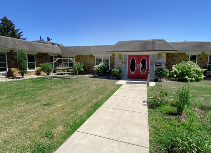 Exterior view of the facility entrance with garden