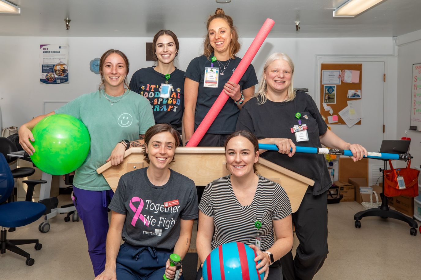 Staff and residents engaging in activities with colorful props
