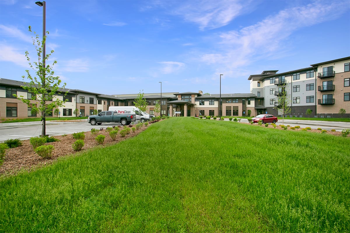 Exterior view of Prairie Gate facility with vehicles
