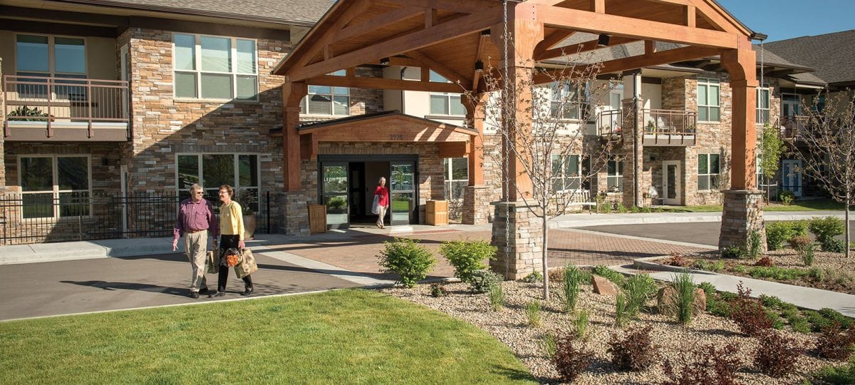 Couple walking in front of the facility's entrance