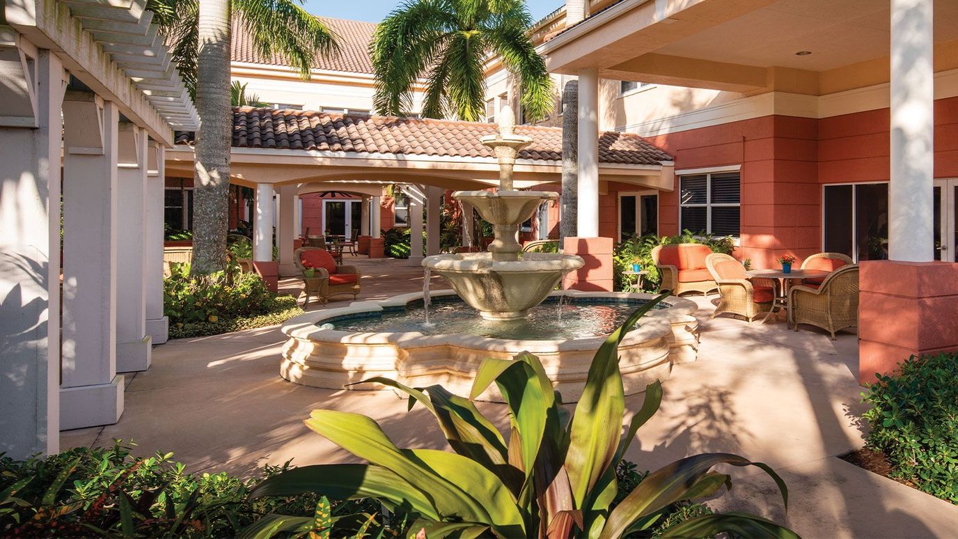 Outdoor courtyard with a fountain and seating area
