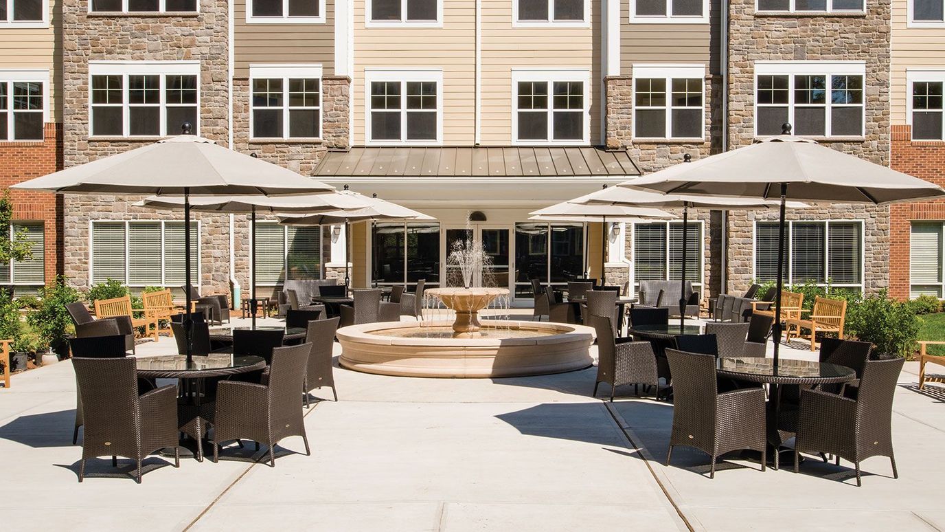 Outdoor seating area with umbrellas and fountain