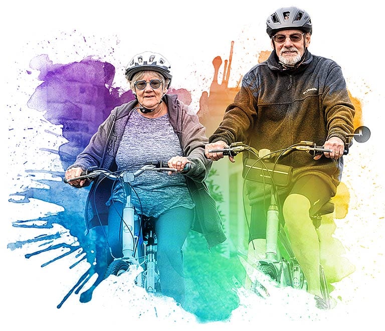 Senior couple riding bicycles with a colorful splash background