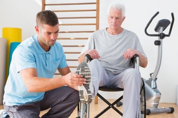 A physical therapist assisting a senior resident