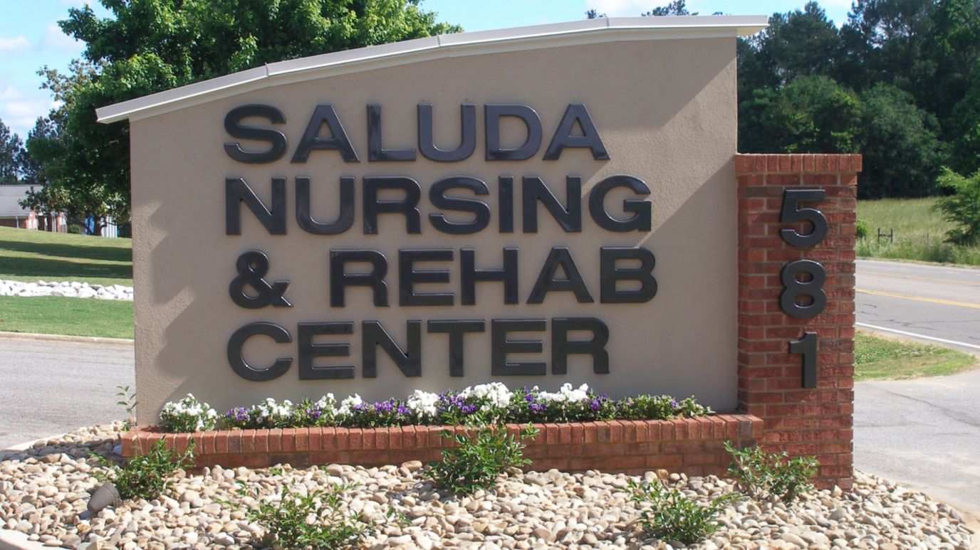 Exterior sign with facility name and flowers
