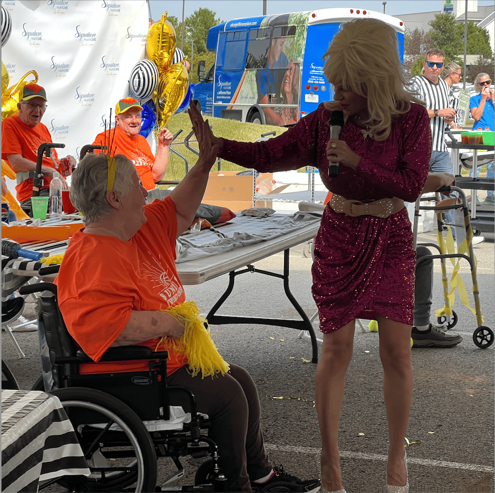 Residents enjoying an activity with a performer outdoors